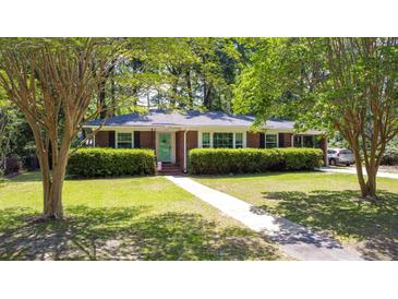 Charming brick home with lush green lawn, manicured hedges, and beautiful mature shade trees at 113 Overhill Dr, Walterboro, SC 29488