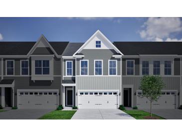 Charming gray townhome with a spacious two-car garage and beautiful architectural details at 124 Brown Swiss Cir, Summerville, SC 29483