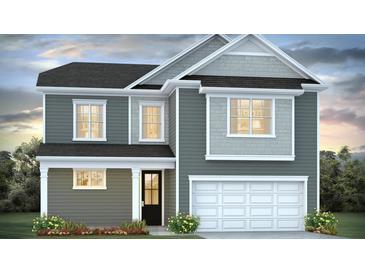 Charming two-story home with an attached two car garage and manicured front yard at 191 E Pinckney St, Summerville, SC 29485