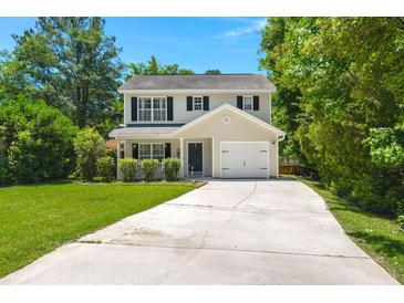 Charming two-story home features a long driveway, one car garage and well-maintained lawn surrounded by mature trees at 214 Blackstone Dr, Moncks Corner, SC 29461