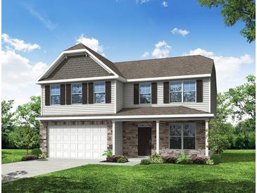 Charming two-story home with stone accents, a covered porch, and a two-car garage at 222 Palfrey Dr, Ridgeville, SC 29472