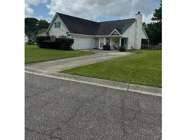 Charming single-story home with a well-manicured lawn and attached two-car garage in a peaceful neighborhood at 2709 Palmetto Hall Blvd, Mount Pleasant, SC 29466