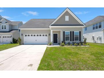 Charming single-Gathering home with a two-car garage and well-maintained lawn, creating curb appeal at 341 Witch Hazel St, Summerville, SC 29486