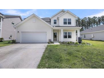 Charming two-story home featuring light siding, a two-car garage and a well maintained lawn at 4308 Cotton Flt Rd, Summerville, SC 29485