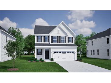 Charming two-story home featuring a two-car garage, black shutters, and a well-manicured lawn at 556 O'Leary Cir, Summerville, SC 29483