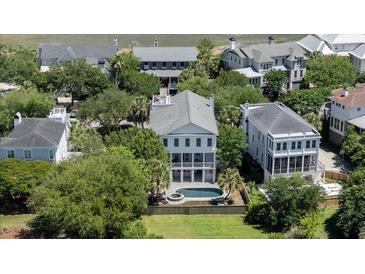 Beautiful aerial view of the home showcasing its pool, well-manicured lawn, and proximity to neighboring houses at 764 Post Oak Dr, Mount Pleasant, SC 29464