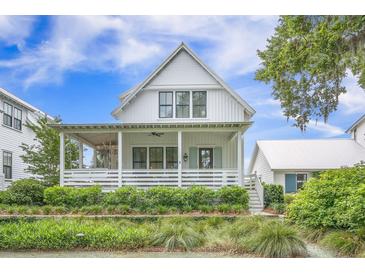 Charming two-story home features a welcoming front porch and manicured landscaping at 7935 Flagship Ln, Johns Island, SC 29455