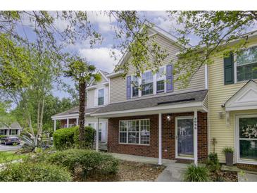 Charming townhome with brick accents, colorful shutters, and lush landscaping at 8096 Shadow Oak Dr Dr, North Charleston, SC 29406