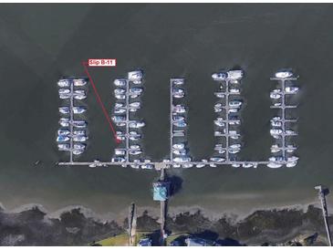 Aerial view of a marina with numerous boats docked in slips, some labeled as B-11 at We 10Th St # B11, Folly Beach, SC 29439