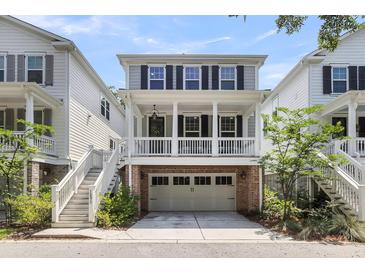 Charming two-story home with a brick-accented garage and a welcoming front porch at 1093 Ave Of Oaks, Charleston, SC 29407