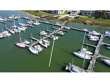 Scenic aerial view of a marina featuring a variety of boats docked in tranquil green waters at 2 Mcdonough Rd # B-11, Folly Beach, SC 29439