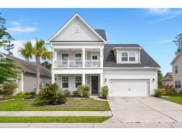 Charming two-story home featuring a double front porch, landscaped yard, and two-car garage at 203 Yeamans Way, Summerville, SC 29483