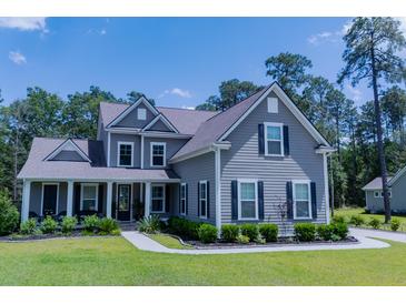 Charming two-story home with a landscaped front yard and inviting covered porch at 3025 Rampart Rd, Summerville, SC 29483