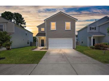 Charming two-story home with a well-maintained lawn and attached two-car garage at 354 Iveson Rd, Summerville, SC 29486