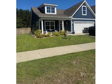 Charming home with a well-manicured lawn and inviting front porch at 359 Whispering Breeze Ln, Summerville, SC 29486