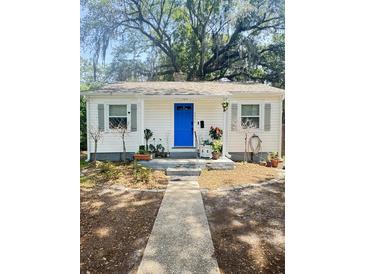 Charming single-story home with a blue front door, gray shutters, and a well-manicured front yard at 4406 Holmes Ave, North Charleston, SC 29405