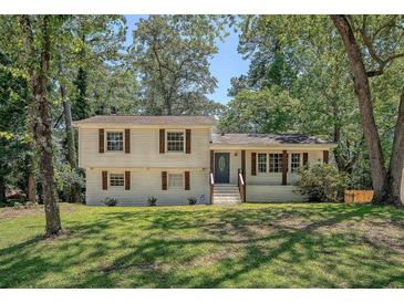 Charming two-story home with well-maintained lawn, mature trees, and inviting front porch at 7639 Hillandale Rd, North Charleston, SC 29420
