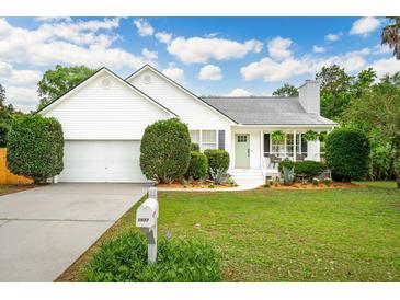 Charming single-story home with a well-manicured lawn, white siding, and an attached garage at 1077 Farmington Rd, Charleston, SC 29412