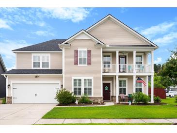 Charming two-story home with a manicured lawn, a two-car garage, and a cozy front porch at 175 Basket Grass Ln, Summerville, SC 29486