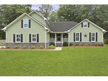 Charming home featuring green siding, black shutters, and a lush green lawn at 189 Fox Chase Dr, Goose Creek, SC 29445
