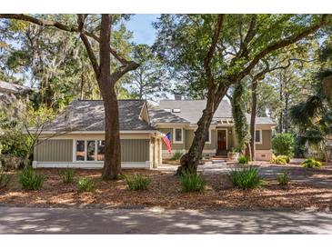 Charming single-story home with mature landscaping and a welcoming front entrance and cozy curb appeal at 2105 Loblolly Ln, Seabrook Island, SC 29455