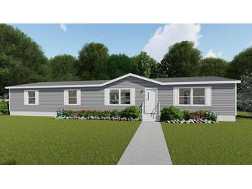 Charming single-story home with gray siding, well-manicured lawn, and inviting landscaping at 282 Marion Rd, Dorchester, SC 29437