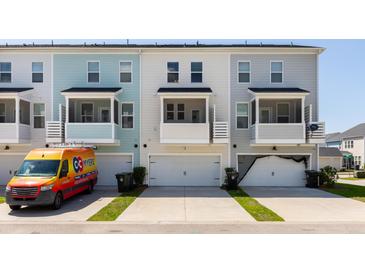 View of townhome exteriors with garages and balconies; note the varying neutral color schemes at 304 Pathfinder Way, Charleston, SC 29492