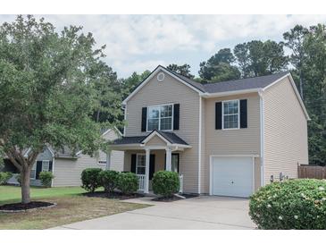 Charming two-story home with black shutters, a well-manicured lawn, and an attached one-car garage at 5094 Thornton Dr, Summerville, SC 29485