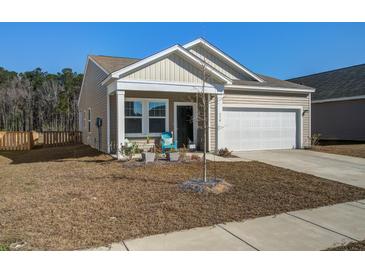 Charming home featuring beige siding, a two-car garage, and a welcoming front porch with colorful seating at 576 Polaris Way, Summerville, SC 29486