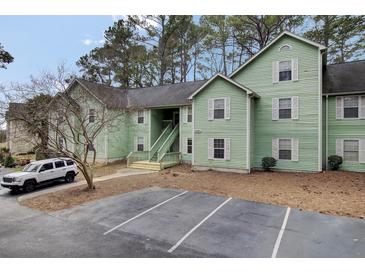 Green multi-Gathering home featuring on-site parking and lush trees at 6241 Rolling Fork Rd # C, North Charleston, SC 29406