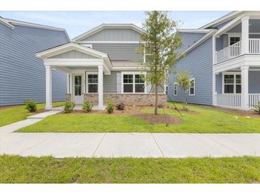 Charming home with a welcoming porch and well-manicured lawn, creating an inviting curb appeal at 133 Brant Dr, Summerville, SC 29483