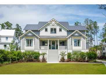 Charming two-story home with landscaped front yard and inviting staircase leading to the entrance at 3871 Sawyers Island Dr, Mount Pleasant, SC 29466