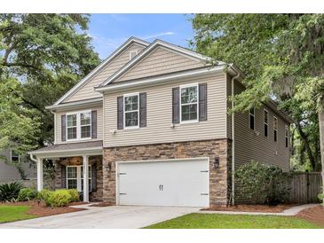 Two-story home with a stone accent front, white garage door, and neutral siding at 3873 Hanoverian Dr, Mount Pleasant, SC 29429