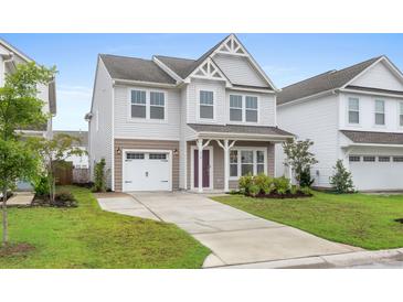 Charming two-story home with a well-manicured lawn, inviting entryway and attached garage at 514 Purple Finch Rd, Summerville, SC 29486