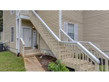 Beige home with wooden stairs leading up to the front door and a welcome sign at 6231 Rolling Fork Rd # 1201-A, North Charleston, SC 29406