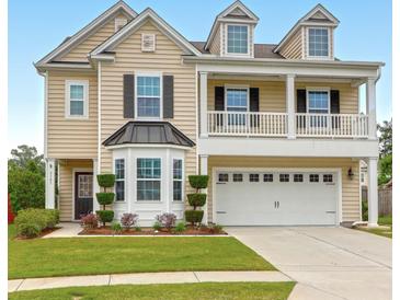 Charming two-story home with landscaped yard, covered porch, and three dormer windows at 9785 Black Willow Ln, Ladson, SC 29456