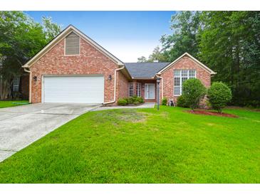 Charming one-story brick home with a well-manicured lawn and attached two-car garage at 100 Cheshire Dr, Goose Creek, SC 29445