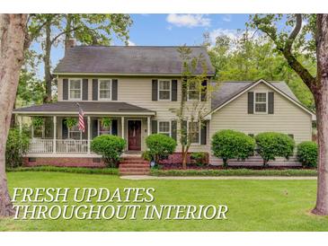 Charming two-story home with a well-maintained lawn and a welcoming front porch at 109 Fort St, Summerville, SC 29485