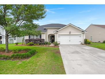 Charming single-story home featuring a well-manicured lawn, inviting curb appeal, and an attached two-car garage at 1103 Cates Ct, Summerville, SC 29483