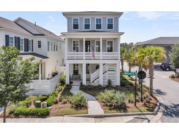 Charming two-story home featuring a welcoming porch, lush landscaping, and a 'Welcome Dr' street sign at 1182 Welcome Dr Dr, Mount Pleasant, SC 29464