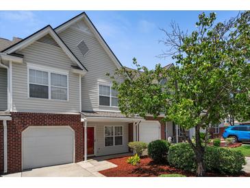 Charming townhome featuring brick accents, an attached garage, and well-manicured landscaping at 125 Greyson Cir, Goose Creek, SC 29445