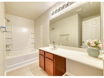 Bright bathroom featuring a large mirror, updated vanity, and a shower-tub combination at 149 Woodward Rd, Goose Creek, SC 29445