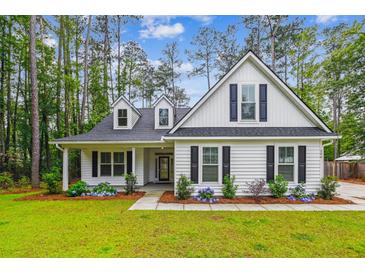 Charming white two-story home with a landscaped front yard and black shutters at 206 Almond Ct, Summerville, SC 29483