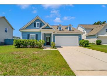 Charming blue home with manicured landscaping, dormers, and a two-car garage at 224 Sugarhouse Ct, Moncks Corner, SC 29461