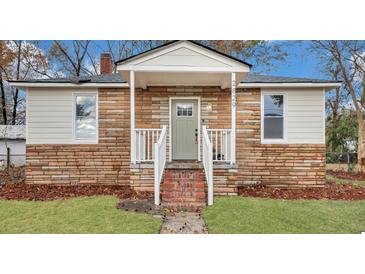 Charming brick home with a covered porch and white railings at 2829 Ranger Dr, North Charleston, SC 29405