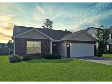 Charming one-story brick home with attached two car garage and well maintained lawn at 286 Westbrooke Rd, Summerville, SC 29486