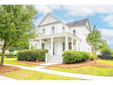 Charming two-story home with a inviting front porch, well-manicured lawn, and lush landscaping at 3707 Gambrill Ln, Mount Pleasant, SC 29466