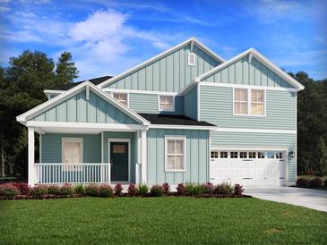 Charming two-story home featuring a welcoming front porch and a two-car garage at 421 Radiant Blue Way, Summerville, SC 29486