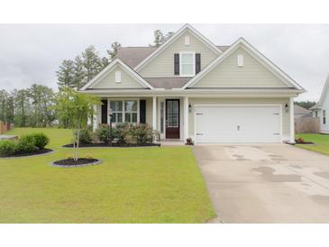 Charming single-Gathering home with a manicured lawn and attached two-car garage at 683 Yellow Leaf Ln, Summerville, SC 29486