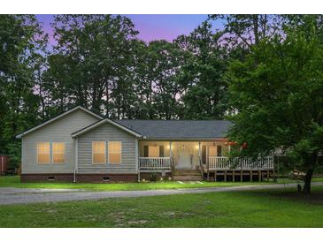 Charming single-story home featuring a cozy porch and landscaped front yard at 785 Coral Acres Dr, Moncks Corner, SC 29461